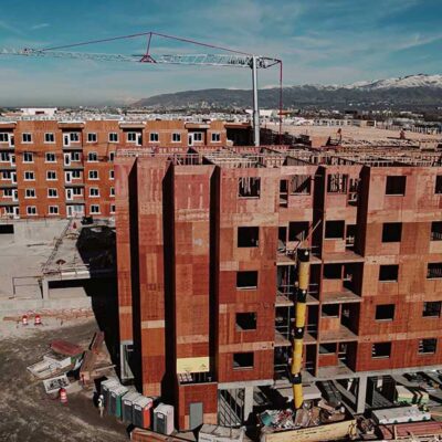 Aerial of apartment building being built with crain