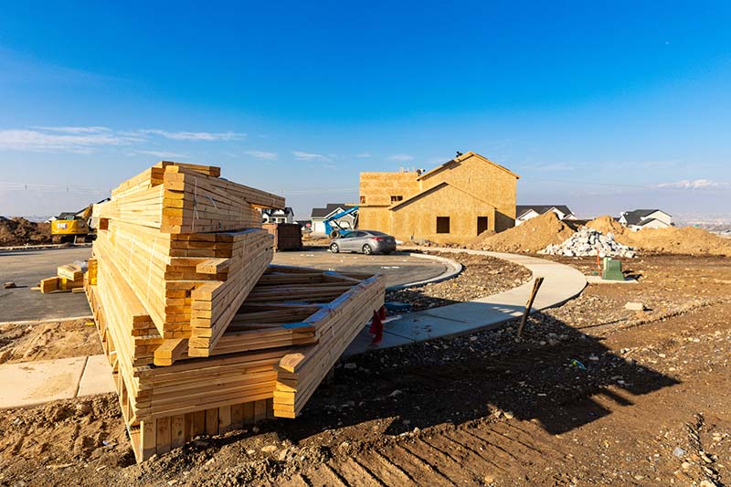 A stack of wood trusses on a construction site