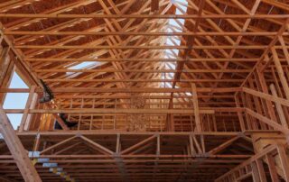 A picture of roof and floor trusses with wood framing