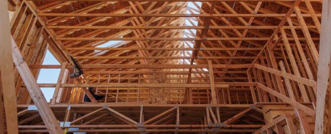 A picture of roof and floor trusses with wood framing