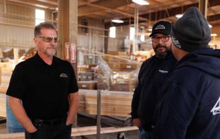 Men having a conversation in a factory building trusses