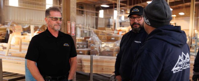 Men having a conversation in a factory building trusses